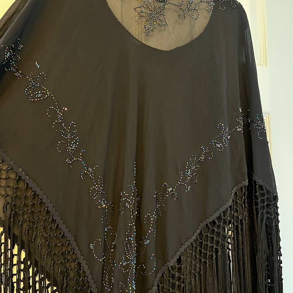 A vibrant elegant and flowing poncho with sparkling sequins PERFECT FOR HOLIDAYS